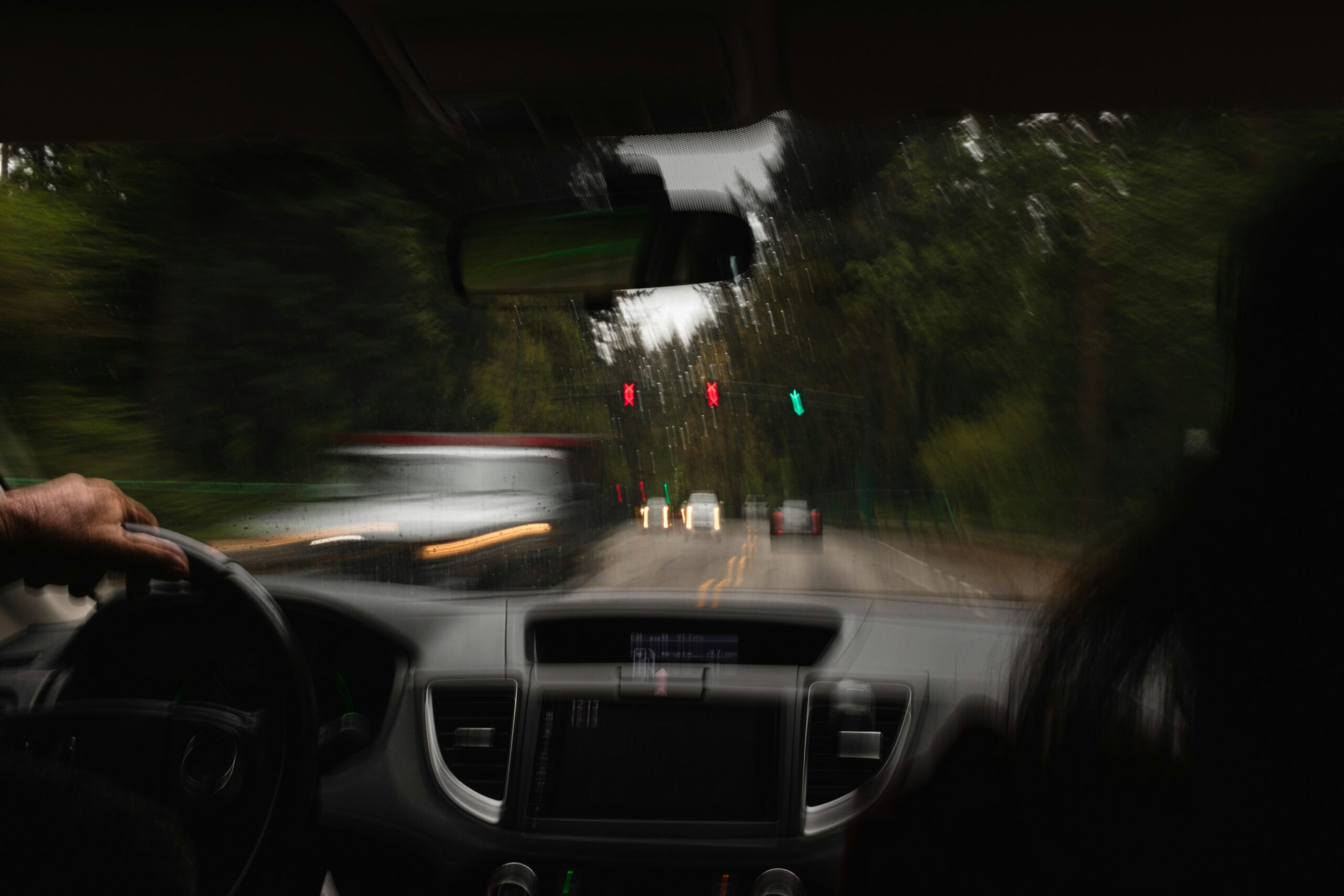 aedrian-salazar-Gl9fJzqlVMQ-unsplash Blurry police car passing car.